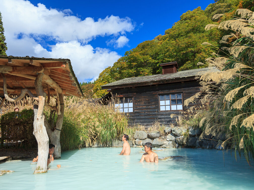 AKITA, JAPAN -OCT 20, 2012: People soaking in outdoor hot spring pool at Tsurunoyu onsen. Tsurunoyu Onsen is one of the oldest hot spring resorts of Nyutou Onsenkyo with a history of over 300 years