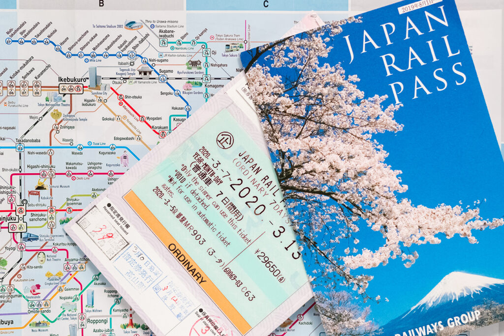 Tokyo - Japan - March 18, 2020 / Two Japan rail pass (JR Pass) over a Tokyo subway map. These passes allow tourists unlimited travel within Japan.